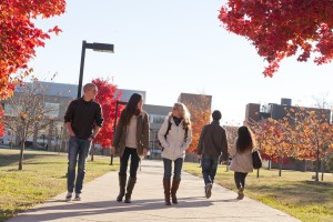 Photo of Students walking on a walkway.